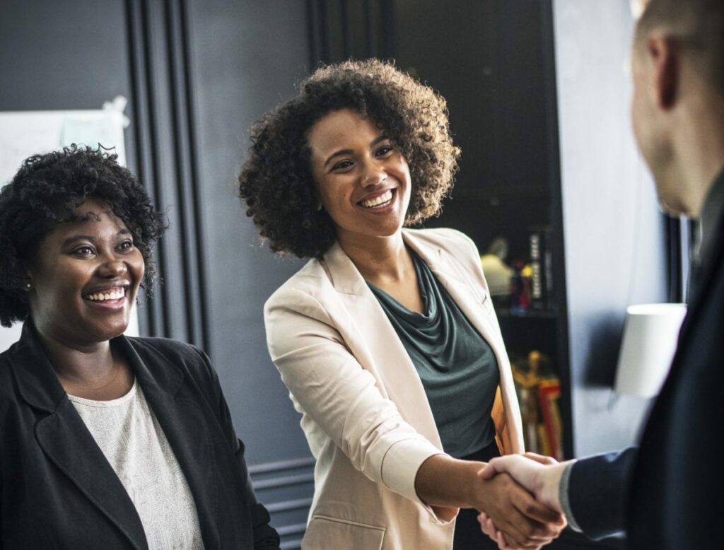 Professional women shaking hands with a man